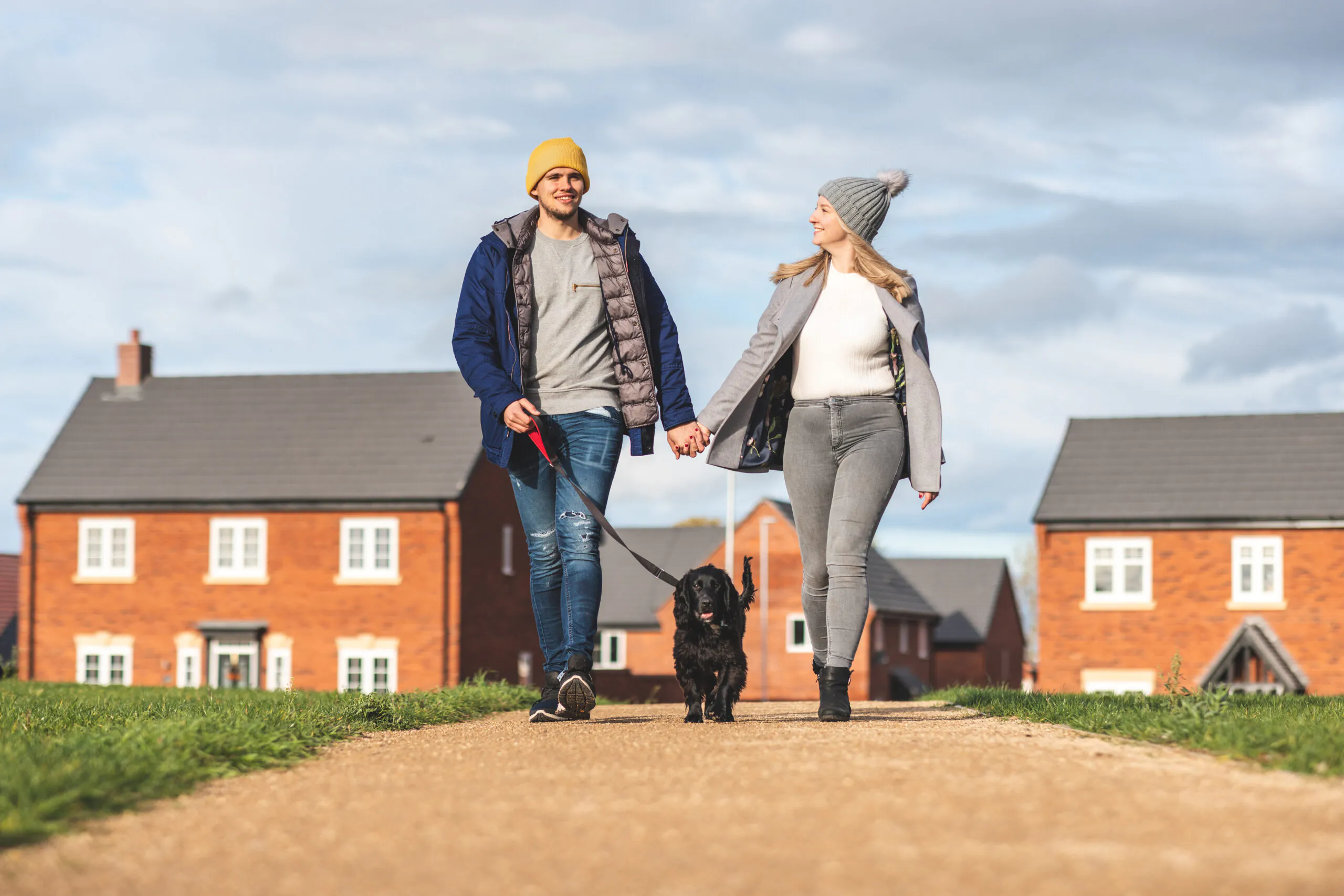 Happy couple walking the dog on a sunny autumn day | Resident Services | Lafford Homes