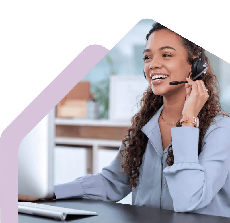 Customer service advisor using a headset at a desk.