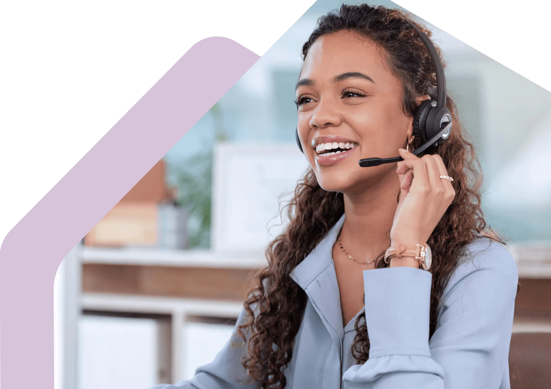 Customer service advisor using a headset at a desk.