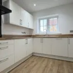 L-shaped kitchen with integrated AEG appliances in The Ruskington, Plot 48 at Beacon Hollow.