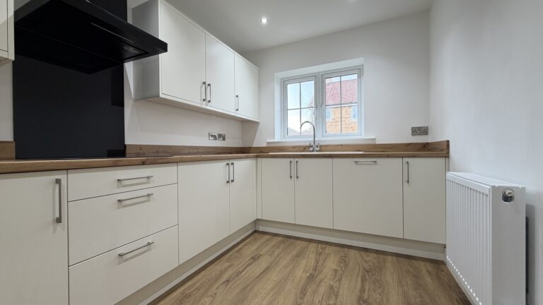 L-shaped kitchen with integrated AEG appliances in The Ruskington, Plot 48 at Beacon Hollow.