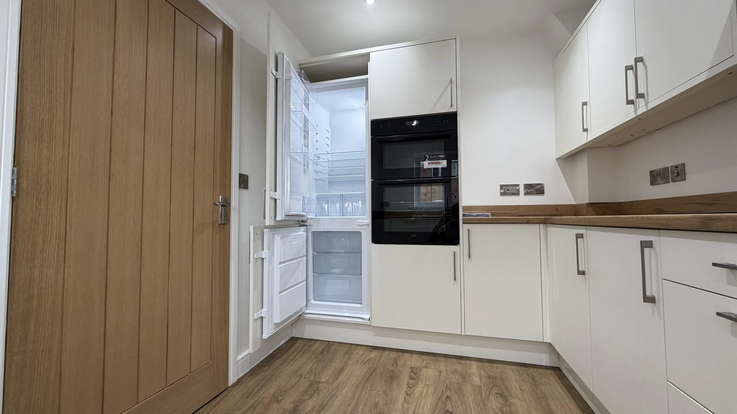 Kitchen showing integrated AEG fridge freezer and double oven in The Ruskington, Plot 48 at Beacon Hollow.