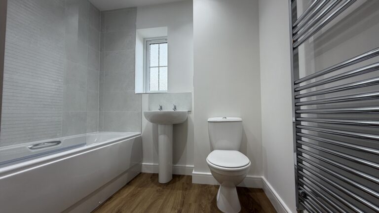 Family bathroom with shower over bath in The Ruskington, Plot 48 at Beacon Hollow