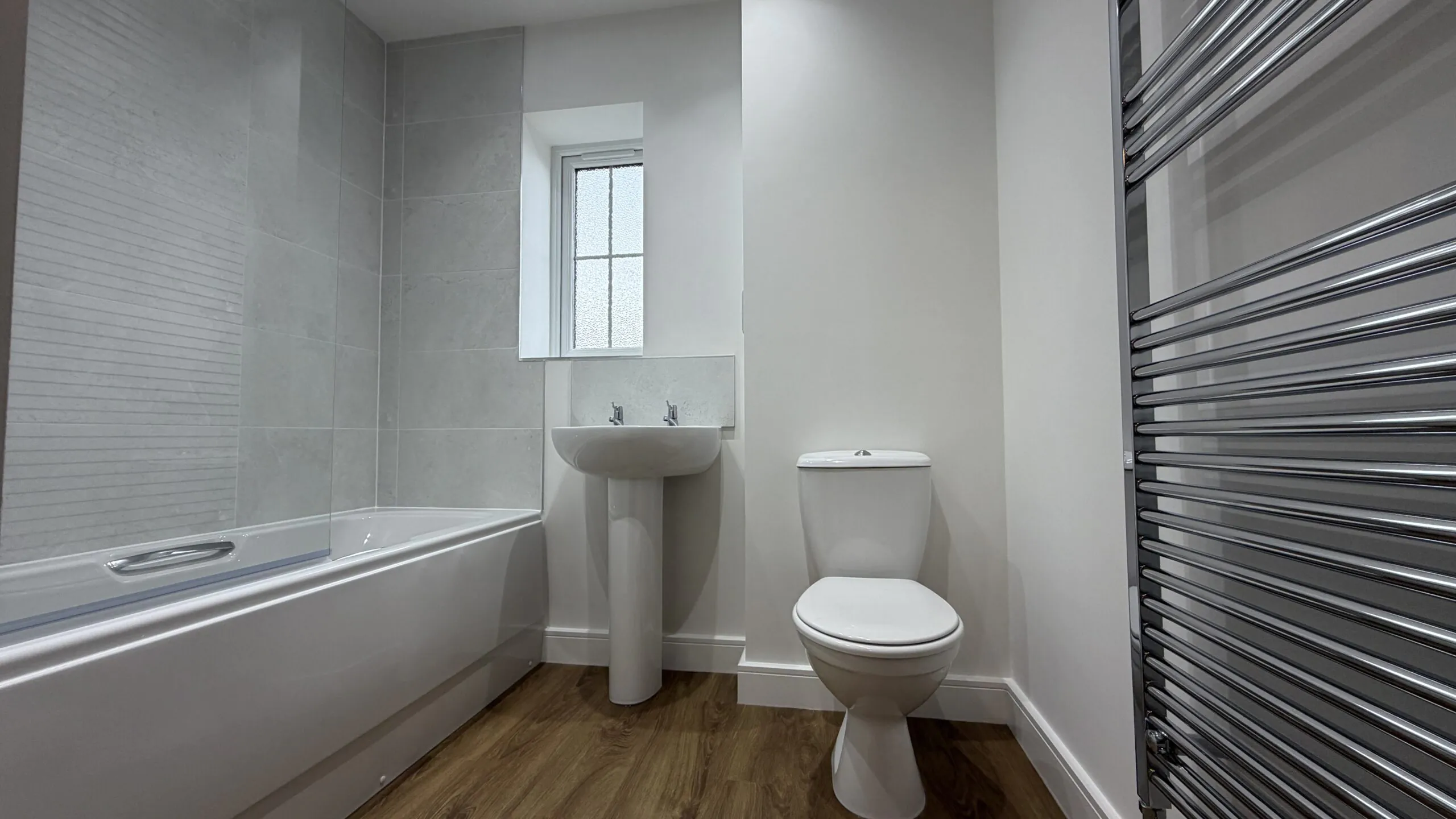 Family bathroom with shower over bath in The Ruskington, Plot 48 at Beacon Hollow