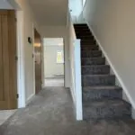Entrance hallway with staircase and view through to living area in The Bardney, Plot 45 at Beacon Hollow.