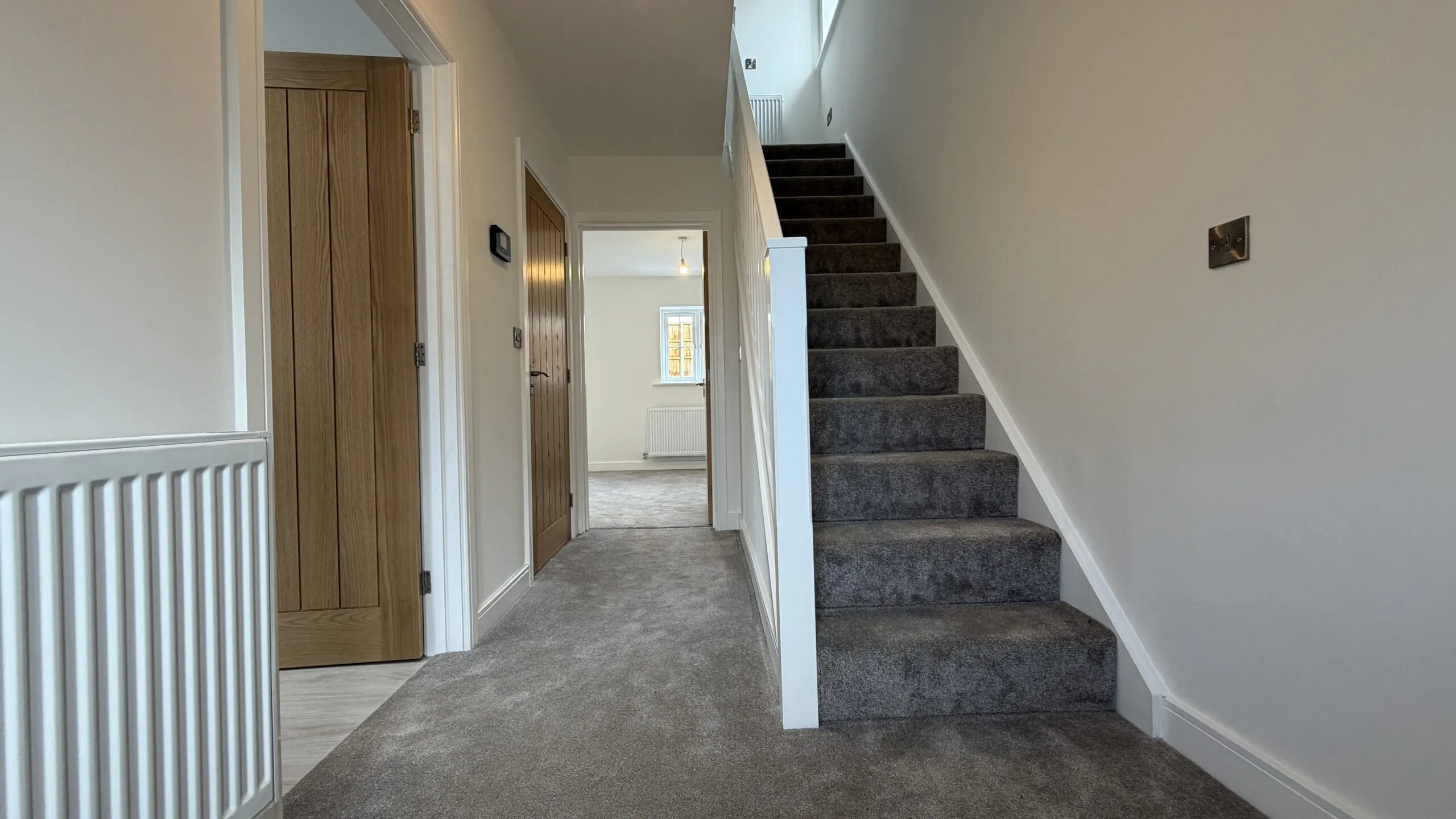 Entrance hallway with staircase and view through to living area in The Bardney, Plot 45 at Beacon Hollow.