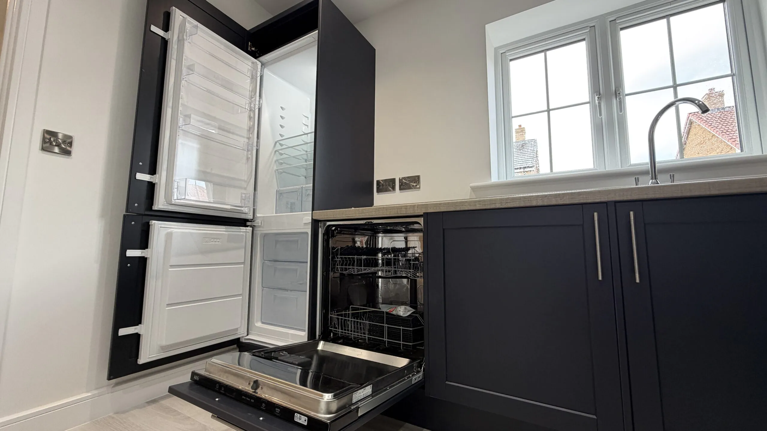 Kitchen with integrated AEG fridge freezer and dishwasher open in The Bardney, Plot 45 at Beacon Hollow.