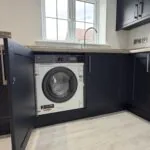 Kitchen with integrated AEG washer dryer in The Bardney, Plot 45 at Beacon Hollow.