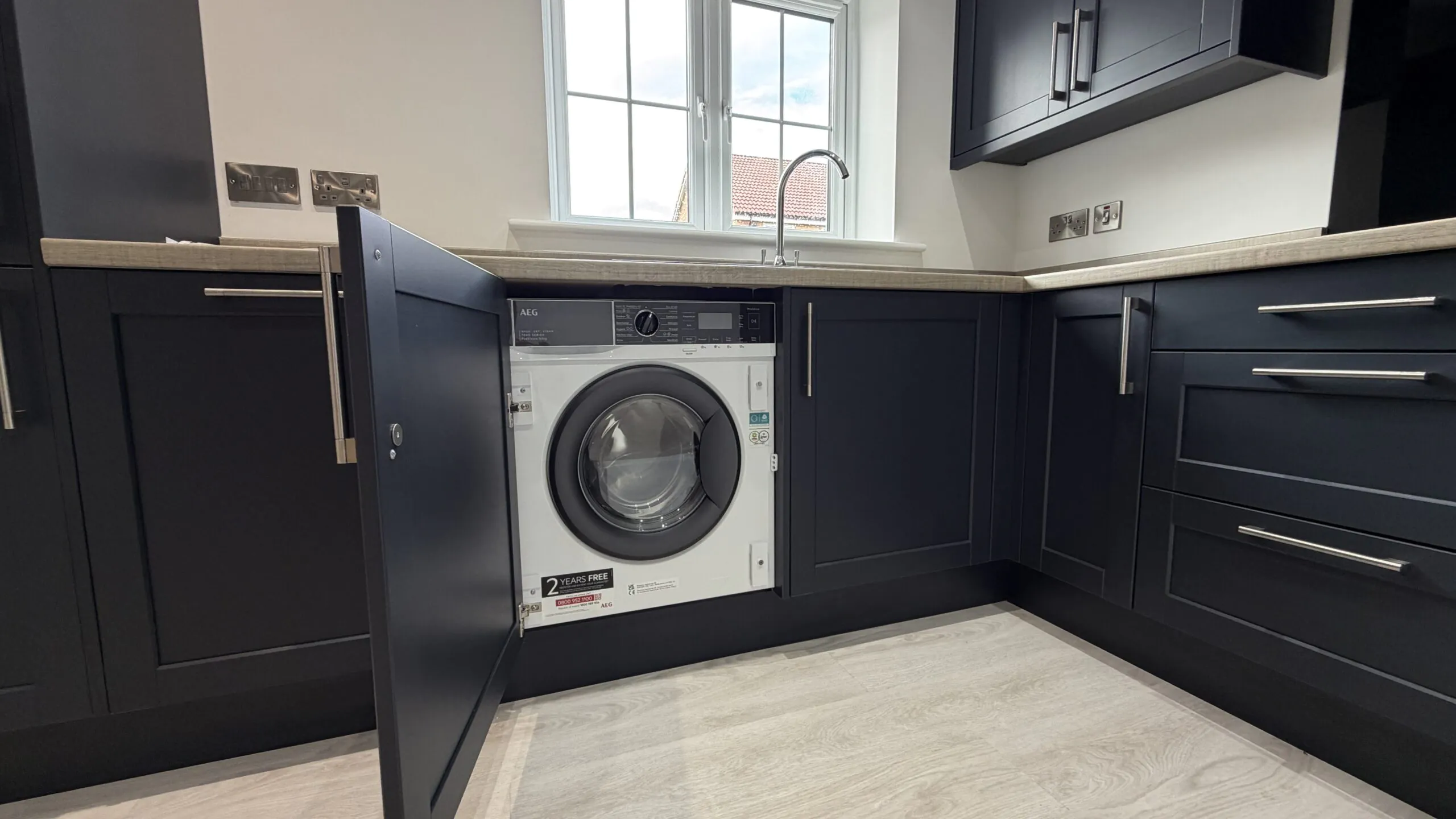 Kitchen with integrated AEG washer dryer in The Bardney, Plot 45 at Beacon Hollow.