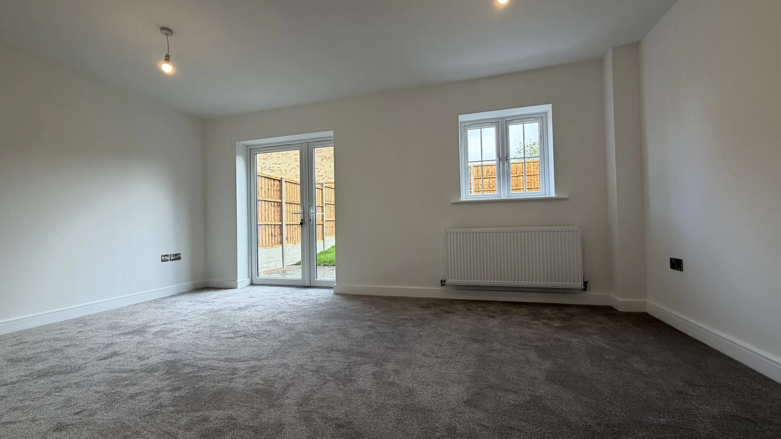 Spacious living room with French doors to garden in The Bardney, Plot 45 at Beacon Hollow.