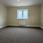 The Waltham at Petrella Place – Bedroom 1 with neutral décor, fitted carpet, double-glazed window and radiator beneath.